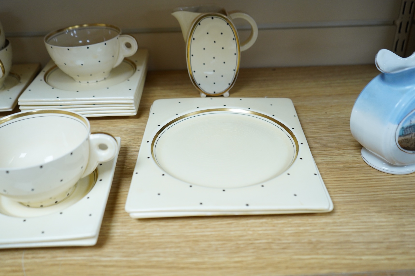 A Clarice Cliff Biarritz-shape 21-piece part teaset including trencher plates and saucers, impressed date-code 1935, jug 13cm